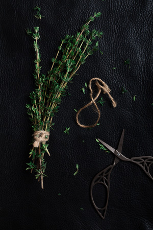 sprigs of thyme dismantled on black background in dark keyの写真素材