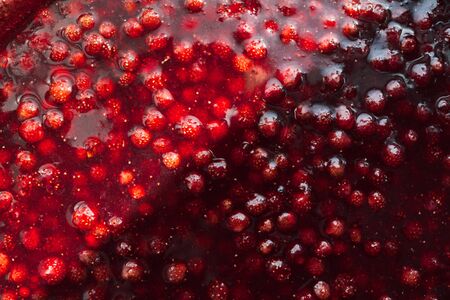strawberry jam texture divided in half by a solar flare, food background gorisontalの写真素材