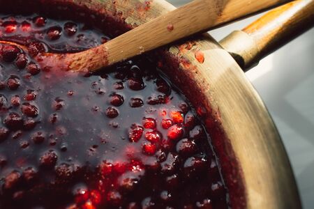 spoon immersed in a bowl with strawberry jam, food backgroundの写真素材