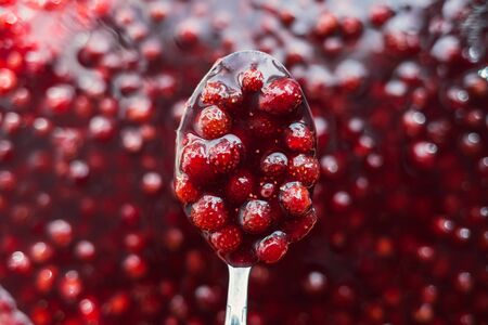 strawberry jam is kept with a metal spoon, shallow depth of fieldの写真素材