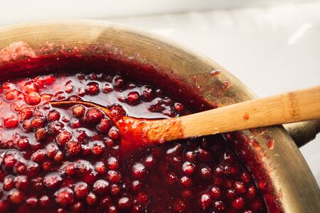 spoon immersed in a bowl with strawberry jam, food backgroundの写真素材