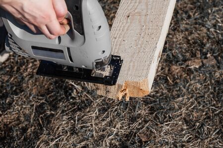 a man saws an electric jigsaw raw Boardの写真素材