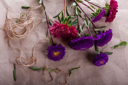cut violet and pink asters are collected in a bouquetの写真素材
