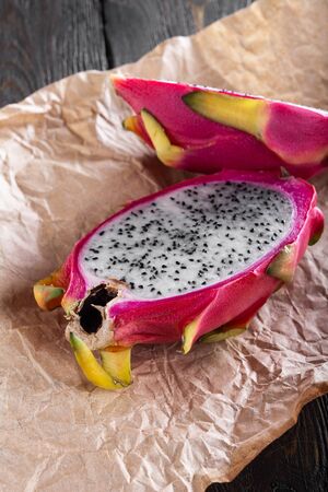 cut fresh pitahaya on a craft paper. verticalの写真素材