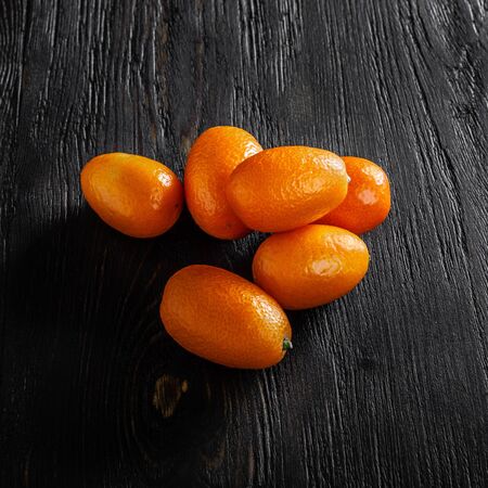 group kumquat fruit on a dark background.の写真素材