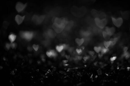 Black and white vintage abstract background with bokeh defocused lights. Heart shapeの写真素材