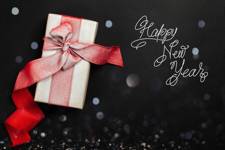Happy New Year. Rady-made card with hand lettering in vintage style. Flat lay gift box with red...