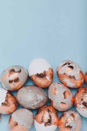 Vertical minimalistic background. Golden eggs are piled at the bottom.