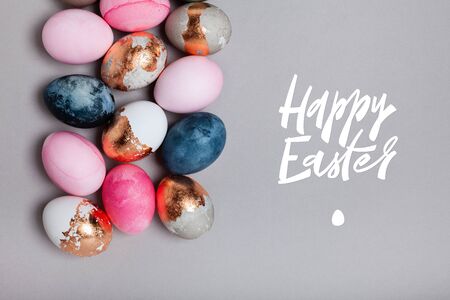 Happy Easter ink brush hand lettering. A wide strip of many multicolored eggs. Easter minimalistic...