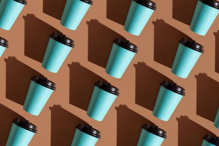 Disposable coffee cup trendy pattern. Brown background.