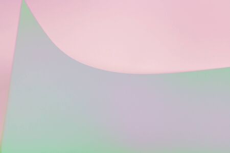 Pink, green and lilac abstract paper background from a curved sheet. Blank for website, advertising,...
