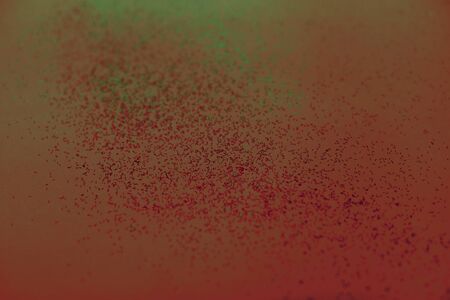 Red-green abstract background with small bokeh defocused lights.の写真素材