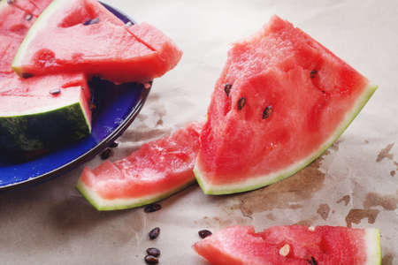 Juicy red watermelon slices lie on the table. Summer food, still life.の写真素材