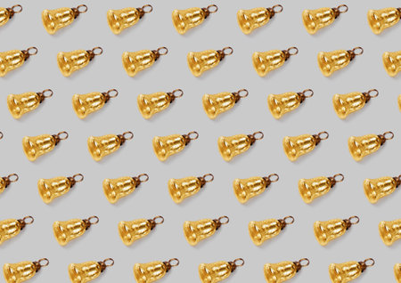 Pattern pattern with christmas tree decorations gold bells on a gray background.の写真素材