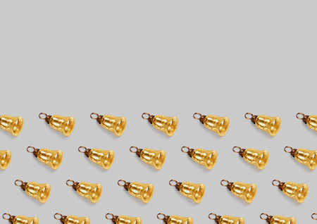 Pattern pattern with christmas tree decorations gold bells on a gray background.の写真素材