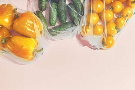 Reusable packaging of products by weight. Bell peppers, cucumbers and tomatoes in a reusable bag on...