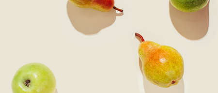 Pattern of pears and apples in sunlight. Modern composition.の写真素材