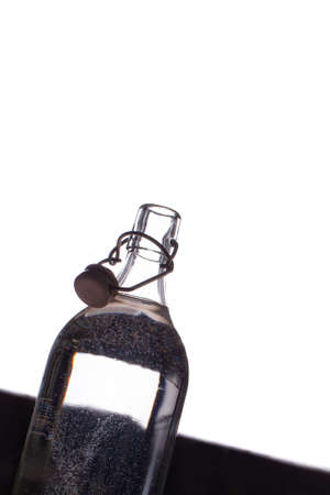 Glass bottle with clean drinking water. Silhouette on the white background.の写真素材