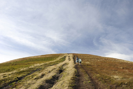Hikers climb the mountainの写真素材