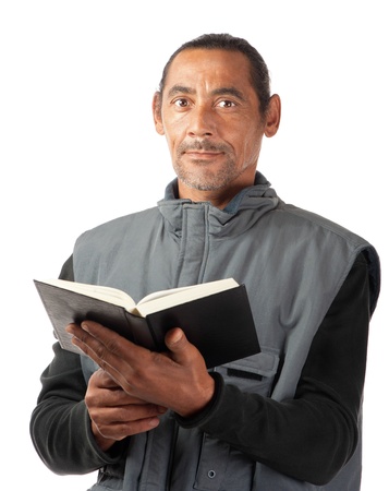 An adult male holds a book in his hands の写真素材