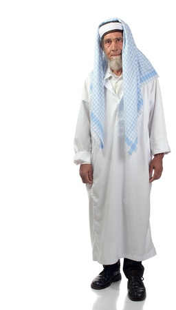 A spiritual senior man with beard and a headdress stands upright.