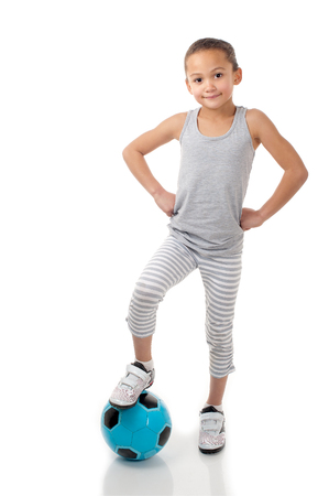 A cheerful young girl is ready to start her soccer game.の写真素材