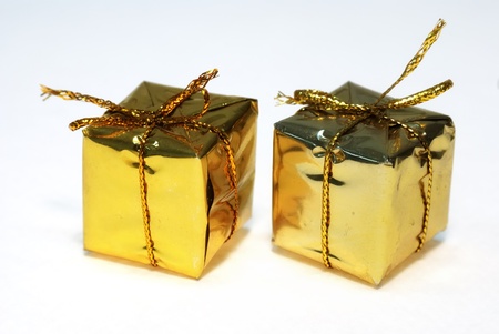 Two golden gift boxes on white backgroundの写真素材
