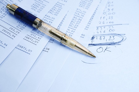 Prints of financial report on a sheets and pen