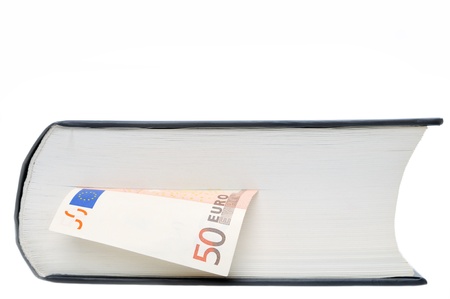Euro banknote between sheets of book isolated on white backgroundの写真素材