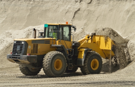 Big yellow bulldozer working on construction siteの写真素材