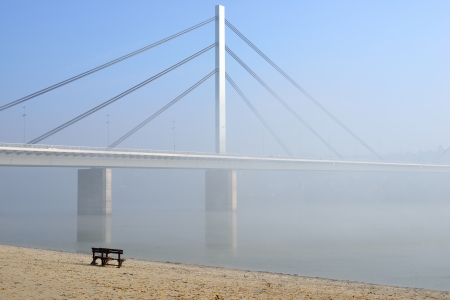 Winter day on Danube river with bridge in fogの写真素材