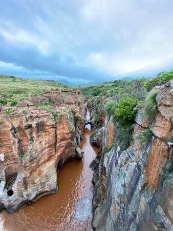 Cloudy day at Bourke's Luck Potholes, South Africa â deep carved river canyon with reddish cliffs and walking paths, top travel destination in Mpumalangaの写真素材