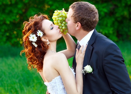 the bride and groom eat green grapesの写真素材