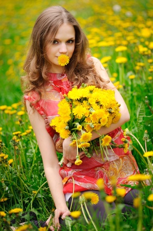 beautiful girl in the field with yellow flowersの写真素材