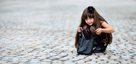 portrait of little girl outdoors in black dressの写真素材