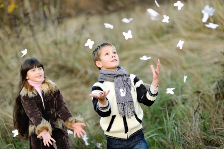portrait of little boy and girl outdoors in autumnの写真素材