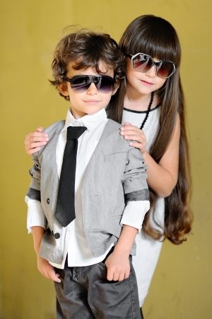 portrait of stylish little boy and girl outdoors の写真素材