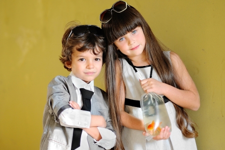 portrait of stylish little boy and girl outdoors の写真素材