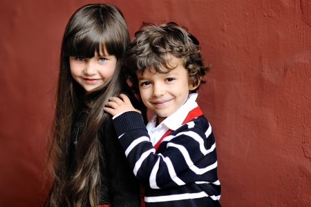 portrait of little boy and girl outdoors in autumnの写真素材