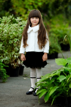 portrait of little girl outdoors in the style of gardenerの写真素材