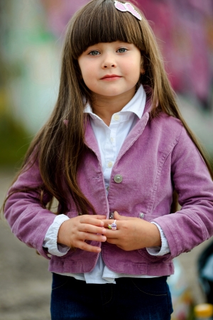 portrait of little girl outdoors in a pink jacketの写真素材