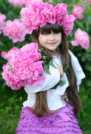 portrait of little girl outdoors with peonyの写真素材