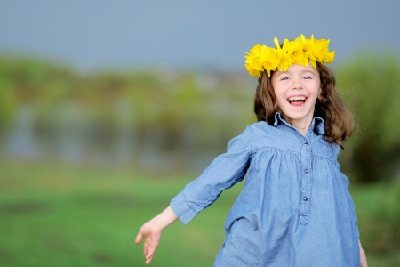 portrait of little girl outdoors with narcissusの写真素材
