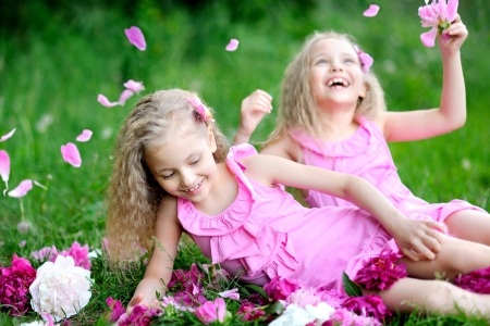 portrait of two twins with peoniesの写真素材