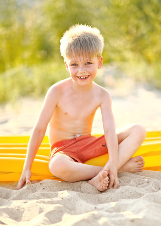 Portrait of a boy on the beach in summerの写真素材