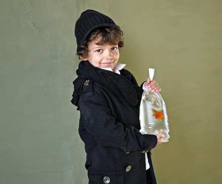 Portrait of a boy with a goldfishの写真素材