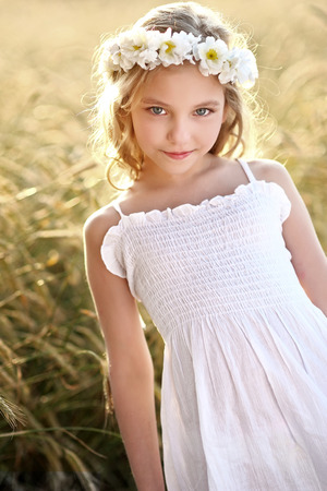 portrait of a beautiful little girl in a fieldの写真素材