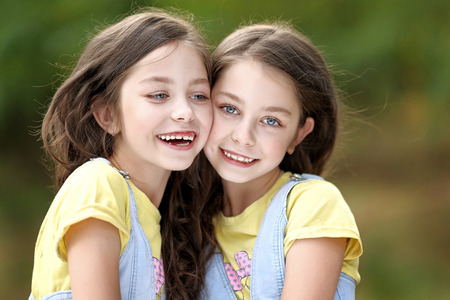 Portrait of two little girls twinsの写真素材