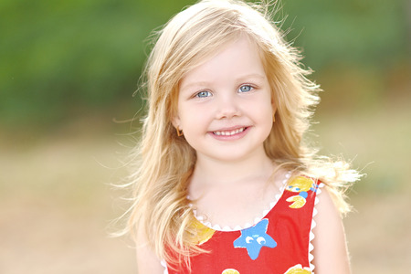 portrait of little girl outdoors in summer