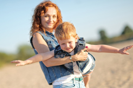 Happy Mom and baby son in summer natureの写真素材